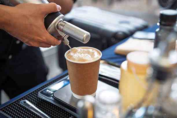 adding whipped cream topping using a dispenser