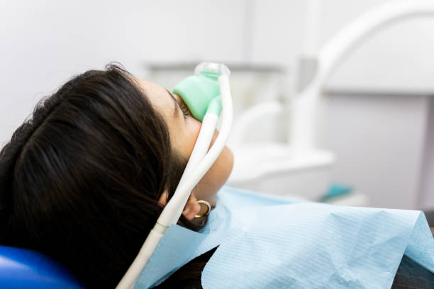 in a dentist's clinic wearing a nasal mask to inhale nitrous oxide